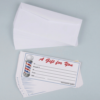 Barbershop gift certificates shown in a stack of 12 as well as the white envelopes stacked along side on a grey background