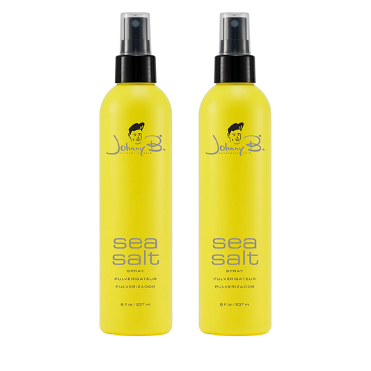 Two Yellow bottles side by side that reads Johnny B Sea Salt spray with a black pump sprayer and clear pump lid on a white background
