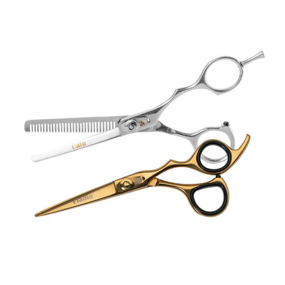 Two professional hairdressing scissors on a white background: one silver with thinning combs and the other gold with black handles.