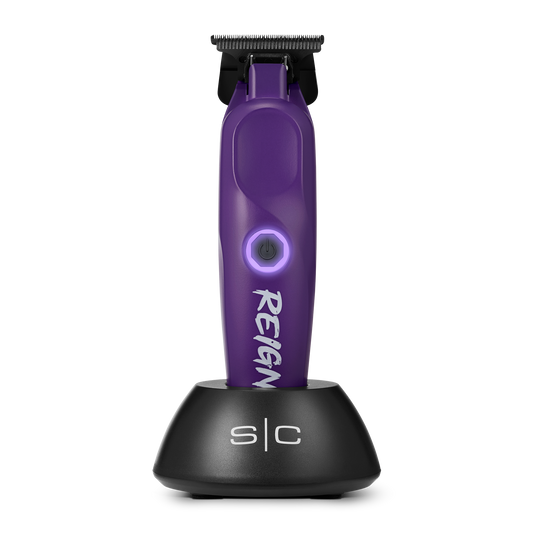 Purple hair trimmer with black stand on a white background