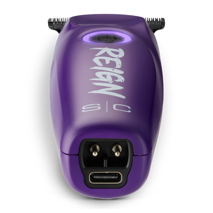 Purple grooming tool with 'REIGN s/c' branding on a white background
