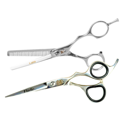 A pair of black-handled barber shears with the brand name 'Eladio' inscribed on the cutting shear and 'Cato' on the thinning shear.
